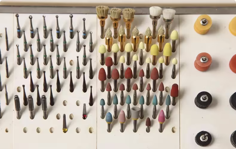 Dental burs, polishing wheels, and orthodontic instruments organized for dental practice